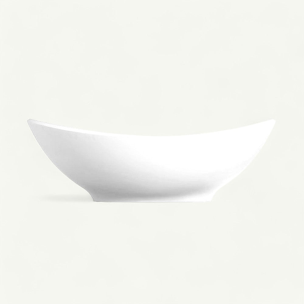Magnus Hartland solid surface stone resin freestanding bathtub in matte white — front studio view showing the dramatic double-slipper profile: a low center rim sweeping up to raised curved ends.